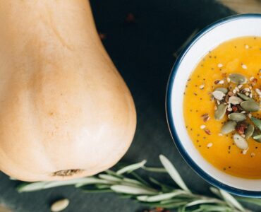 image shows a butternut squash and bowl of soup
