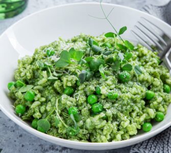 Tasty looking green pea risotto in a nice white bowl